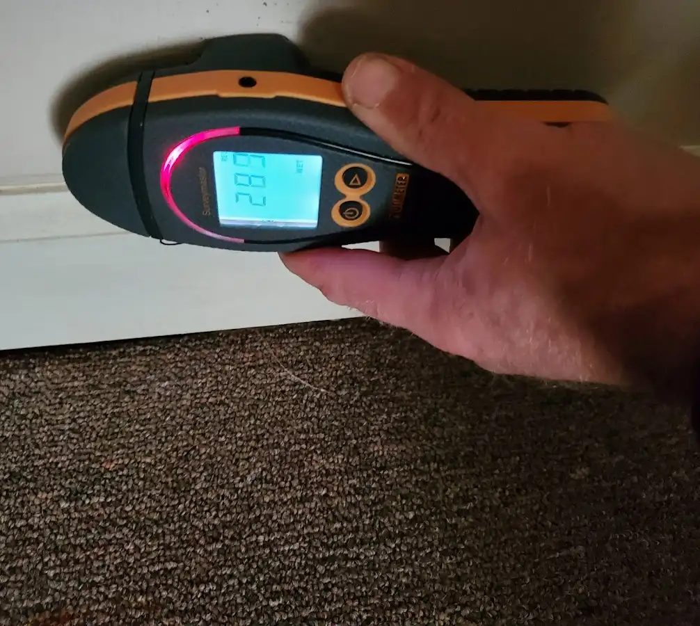 Moisture detection at baseboard during Storm Damage Restoration in East Earl